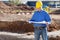 Businessman Examining Blueprint At Construction Site