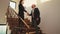 Businessman and executive manager shaking hands on stairs