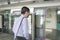 Businessman with face mask on entering into a waiting subway train