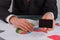 Businessman or financier giving a business card while sitting at the table.