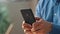 Businessman fingers holding smartphone cabinet closeup. Man texting mobile phone