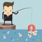 Businessman fishing money by magnet