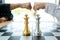 Businessman fist bump  near the chess board silver and gold color on the office desk