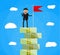 Businessman with flag standing on money stairs