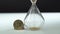 Businessman flips the clock and countdown starts. Hourglass and gold crypto coin Bitcoin on white surface with dark