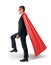 A businessman in a flowing red cape stepping on an invisible ladder. Moving forward.