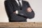 Businessman with folded arms with wall of wooden bricks infront