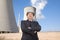 Businessman in front of cooling tower