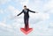 Businessman full-faced walking straight balancing on giant red arrow