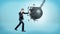 A businessman in full height punching and breaking a huge wrecking ball on blue background.