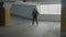 Businessman funny dancing and jumping joyfully in a underground parking lot to express his happiness of being promoted -