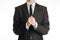 Businessman and gesture topic: a man in a black suit with a tie folded his hands in front of him and praying, meditating