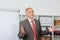 Businessman Gesturing While Giving Presentation In Office