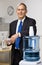 Businessman getting water from water cooler