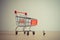 Businessman and giant shopping cart. Budget or consumerism concept. Macro photo