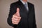 Businessman give a thumbs up for compliment as praise, congratulate, good and like concept