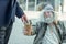 Businessman giving one dollar bill to poor street musician