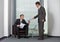 Businessman giving paper to colleague in office