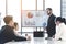 Businessman Giving Presentation Report to Business Team in the Conference Room, Shows Digital Information Graphics, Pie Charts