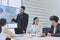 Businessman Giving Presentation Report to Business Team in the Conference Room, Shows Digital Information Graphics, Pie Charts