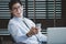 Businessman in glasses sitting at office desk with laptop