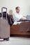 Businessman in glasses working on laptop after coming on business trip