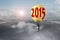 Businessman in glowing yellow lightbulb 2015 hot air balloon fly