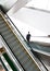 Businessman going down the escalator