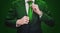 Businessman in green suit tying green necktie. Environment, agriculture and green business