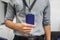 Businessman with grey shirt hold neck company badge in office