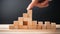 Businessman hand arranging wooden block stacking as step stair to success