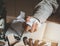 Businessman hand clenching a piece of white paper in anger and office supplies on desk of working.