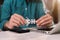 Businessman hand connecting jigsaw puzzle with calculator at office.