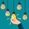 A businessman hand grabs a bright light bulb. Business idea vector