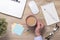 Businessman hand holding cappuchino coffee cup on table.