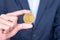 Businessman hand holding golden Dash cryptocurrency coin, Crypto is Digital Money within the blockchain network, is exchanged