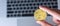 Businessman hand holding golden Dash Cryptocurrency coin over keyboard laptop, Crypto is Digital Money within the blockchain