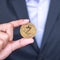 Businessman hand holding golden ZCASH ZEC cryptocurrency coin, Crypto is Digital Money within the blockchain network, is