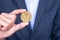 Businessman hand holding golden ZCASH ZEC cryptocurrency coin, Crypto is Digital Money within the blockchain network, is