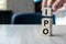 Businessman hand holding IPO Initial Public Offering word with wooden cube block, shares of a private corporation to the public