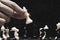 Businessman hand holding and moving white king chess figure with competitor to success play. Business management   competition and