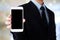 Businessman hand holding smartphone with blank on screen display