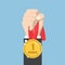 Businessman hand holding winner medal