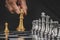 Businessman hand moving gold king with silver chess pieces on chess board game competition