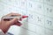 Businessman hand planning his schedule on the whiteboard