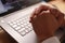 Businessman hand in pray gesture in front of laptop computer