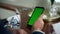 Businessman hand swiping green smartphone screen closeup. Man use mockup device