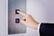 Businessman hand touching going up sign on lift control panel