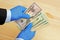 Businessman hands in blue medical gloves counting dollar banknotes