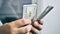 Businessman hands counting cash hundred dollars